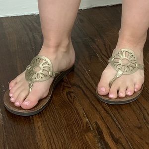 Gold and brown flip flops
